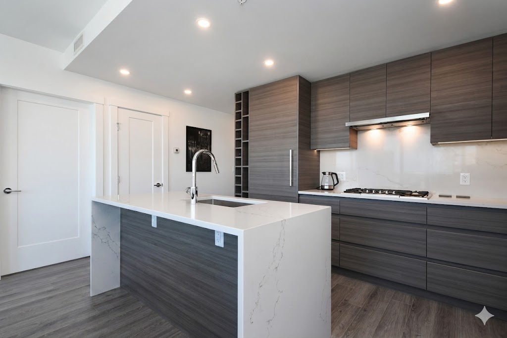 1106kitchen1 | Apartments Homes Suites for Rent Victoria BC Modern kitchen with a large white island sleek grey wood cabinets and a stainless steel faucet