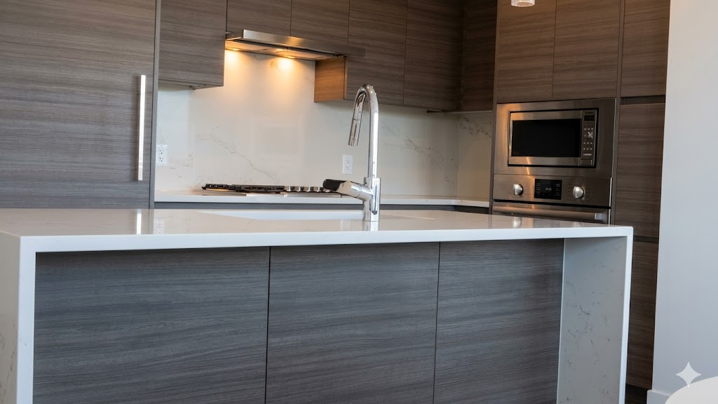 1106kitchen2 | Apartments Homes Suites for Rent Victoria BC Modern kitchen with dark wood cabinets white island countertop and stainless steel appliances including microwave and oven